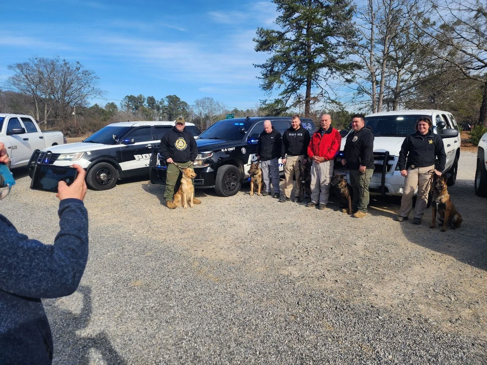 A full class of K9 officers and their certified detection dogs with patrol vehicles